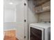 Laundry room with white washer and dryer and built-in storage shelves at 273 12Th Ne St # 421, Atlanta, GA 30309