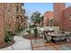 The outdoor patio has dining table and chairs, along with stainless steel gas grills in a brick surround at 273 12Th Ne St # 421, Atlanta, GA 30309