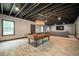 A basement area with an exposed ceiling, a pool table, and a comfortable seating area at 2927 Dolostone Way, Dacula, GA 30019