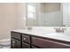 Bathroom featuring double sinks, wood cabinets, and a shower-tub combo at 2927 Dolostone Way, Dacula, GA 30019