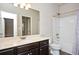 Bathroom featuring a double vanity with dark cabinets, a toilet, and a shower-tub combo at 2927 Dolostone Way, Dacula, GA 30019