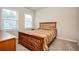 Bedroom featuring a wood frame bed and two windows letting in natural light at 2927 Dolostone Way, Dacula, GA 30019