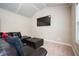 Inviting bonus room with a large wall-mounted TV, vaulted ceiling and a comfortable seating area at 2927 Dolostone Way, Dacula, GA 30019