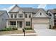Beautiful two-story brick home featuring a well-manicured lawn, covered porch, and attached two-car garage at 2927 Dolostone Way, Dacula, GA 30019