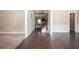 Elegant foyer featuring dark hardwood floors, wainscoting, and an open view to the living spaces beyond at 2927 Dolostone Way, Dacula, GA 30019