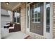 Inviting front porch with seating area, a welcome mat, and stylish front door creating a warm entry at 2927 Dolostone Way, Dacula, GA 30019