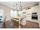 Bright eat-in kitchen with stainless appliances, white cabinets, granite counters, island with seating and hardwood floors at 2927 Dolostone Way, Dacula, GA 30019