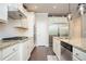 Bright eat-in kitchen with stainless appliances, white cabinets, granite counters, island with seating and hardwood floors at 2927 Dolostone Way, Dacula, GA 30019