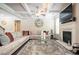 Comfortable living room with a fireplace, soft rug, sectional sofa and decorative accents at 2927 Dolostone Way, Dacula, GA 30019