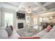 Cozy living room featuring a fireplace, plush rug, comfortable seating, and an open floor plan at 2927 Dolostone Way, Dacula, GA 30019