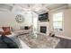 Spacious living room with fireplace, TV, comfy seating, a large rug, and stylish decor at 2927 Dolostone Way, Dacula, GA 30019