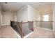 Spacious upstairs landing featuring a neutral color palette, carpeted floors and decorative railings at 2927 Dolostone Way, Dacula, GA 30019