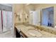 Granite-topped vanity in a well-lit bathroom with a mirror and a shower with curtain in the background at 4892 Kentwood Dr, Marietta, GA 30068