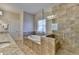 Bathroom featuring a soaking tub, double granite vanity, and a separate glass-enclosed shower at 4892 Kentwood Dr, Marietta, GA 30068