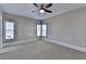 Neutral bedroom with plush carpet, natural light from two windows, and a ceiling fan at 4892 Kentwood Dr, Marietta, GA 30068