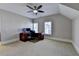 Bedroom featuring a desk and dual monitors in an upper bonus room with two windows for natural light at 4892 Kentwood Dr, Marietta, GA 30068