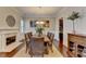 Open dining room featuring a fireplace, wood floors, large table, and crown molding at 4892 Kentwood Dr, Marietta, GA 30068