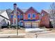 Charming brick home featuring a stone chimney, two-car garage and professionally landscaped front yard at 4892 Kentwood Dr, Marietta, GA 30068