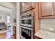 A modern kitchen featuring stainless steel double ovens and custom cabinets at 4892 Kentwood Dr, Marietta, GA 30068