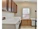 Laundry room featuring a washer and dryer, storage cabinets, and natural light from a window at 4892 Kentwood Dr, Marietta, GA 30068