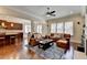 Open-concept living room showcasing the kitchen, hardwood floors, comfortable furniture, and abundant natural light at 4892 Kentwood Dr, Marietta, GA 30068