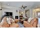 Cozy living room featuring a fireplace, ceiling fan, hardwood floors, and comfortable leather furniture at 4892 Kentwood Dr, Marietta, GA 30068