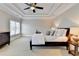 Relaxing bedroom features a tray ceiling, a ceiling fan, neutral paint, and a large window at 4892 Kentwood Dr, Marietta, GA 30068