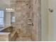 Tile shower with glass door and built-in shelving, complemented by a modern showerhead at 4892 Kentwood Dr, Marietta, GA 30068