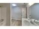 Bright bathroom featuring a white vanity, modern faucet, shower, and plank flooring at 5326 Nader Pl, Stone Mountain, GA 30088