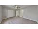 Spacious bedroom featuring new carpet, a ceiling fan, and a double-door closet at 5326 Nader Pl, Stone Mountain, GA 30088