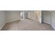 An airy bedroom with neutral walls, soft carpet, and a doorway for a welcoming space at 5326 Nader Pl, Stone Mountain, GA 30088