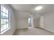 Well-lit bedroom featuring neutral walls, carpet, and multiple windows offering natural light at 5326 Nader Pl, Stone Mountain, GA 30088