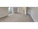 Bright bedroom with neutral walls, plush carpet, a window, and a doorway for a cozy feel at 5326 Nader Pl, Stone Mountain, GA 30088