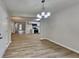 A dining area with modern light fixture adjacent to an open kitchen with stainless appliances at 5326 Nader Pl, Stone Mountain, GA 30088