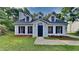 Charming home with a well-manicured lawn and a dark-blue front door, showcasing curb appeal at 5326 Nader Pl, Stone Mountain, GA 30088