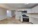 Bright kitchen featuring modern appliances, white cabinets, and new laminate floors at 5326 Nader Pl, Stone Mountain, GA 30088