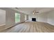 Spacious living room featuring new flooring, a fireplace, and natural light through large windows at 5326 Nader Pl, Stone Mountain, GA 30088