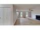 Open-concept living area featuring new laminate flooring and a cozy fireplace at 5326 Nader Pl, Stone Mountain, GA 30088