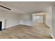 Open layout shows the living room fireplace, new flooring, and view into the adjacent dining area at 5326 Nader Pl, Stone Mountain, GA 30088