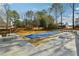 Backyard view with a large covered pool, picnic tables, fenced yard, and mature trees at 360 Wynbrook Dr, Mcdonough, GA 30253