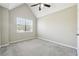 This carpeted bedroom has a ceiling fan and a window with light coming through at 360 Wynbrook Dr, Mcdonough, GA 30253