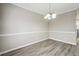 Cozy dining room with wood-look flooring and a modern chandelier at 360 Wynbrook Dr, Mcdonough, GA 30253