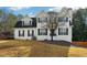 Traditional two-story home with white stucco, black shutters, and a well-maintained front lawn at 360 Wynbrook Dr, Mcdonough, GA 30253