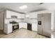 Bright kitchen featuring white cabinets, stainless steel appliances and wood flooring at 360 Wynbrook Dr, Mcdonough, GA 30253