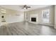 Spacious living room boasts wood-look floors, a fireplace, and ample natural light at 360 Wynbrook Dr, Mcdonough, GA 30253