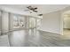 Open-concept living room featuring wood-look flooring, staircase, and a bright entryway at 360 Wynbrook Dr, Mcdonough, GA 30253