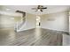 Bright, open-concept living room with wood-look flooring, staircase, and neutral decor at 360 Wynbrook Dr, Mcdonough, GA 30253