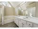 Main bathroom with a double sink vanity, large mirror, and separate shower and tub at 360 Wynbrook Dr, Mcdonough, GA 30253
