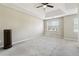 Main bedroom with tray ceiling, ceiling fan and neutral colored walls at 360 Wynbrook Dr, Mcdonough, GA 30253