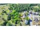 An aerial view of a home with a spacious yard surrounded by lush trees, yellow property outline shown at 556 Georgia Cir, Loganville, GA 30052
